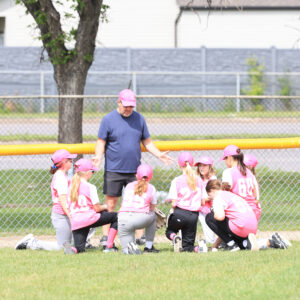 coach with all girls baseball team